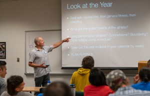 Steve Bechtel point to a screen during a lecture.